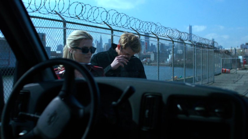 Will and Trish look over a van by the river.