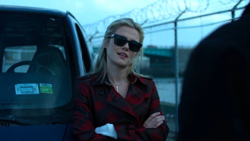 Trish leaning against a van by the river.