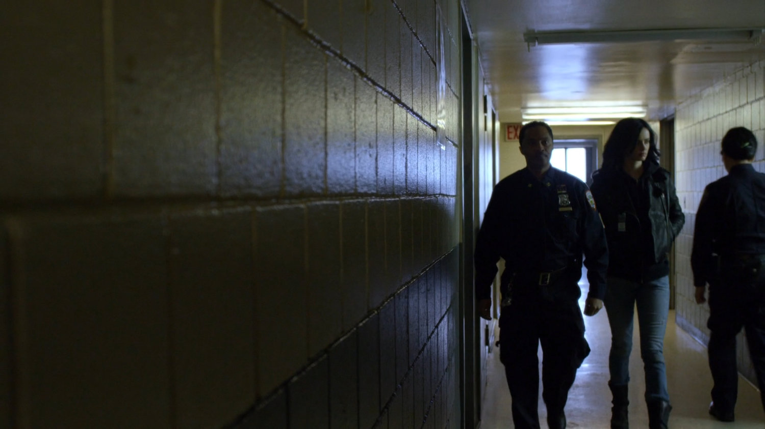 Jessica and guard in hallway at Northeastern Correctional Facility.