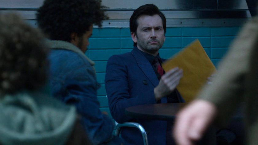 Kilgravetaking envelope from Malcom outside a coffee shop.