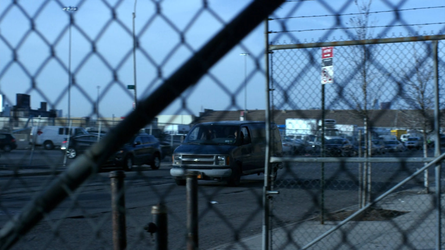 Van driving along street outside decommissioned CDC facility.
