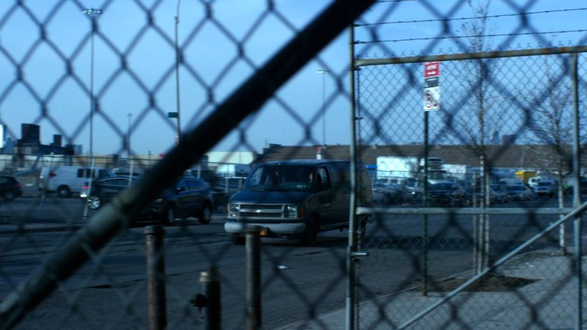 Van driving along street outside decommissioned CDC facility.