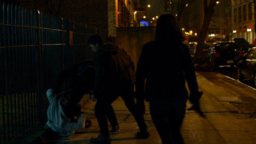 Jessica approaching Malcolm getting mugged on sidewalk.