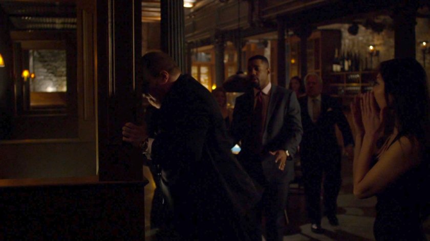 Harvey beating his head against a post in a dark back room of a private club used for poker.