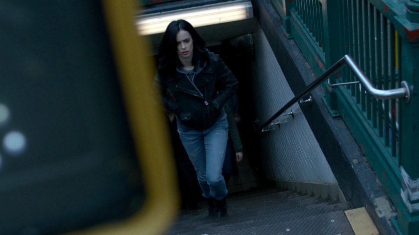 Jessica walking up stairs from a subway exit.