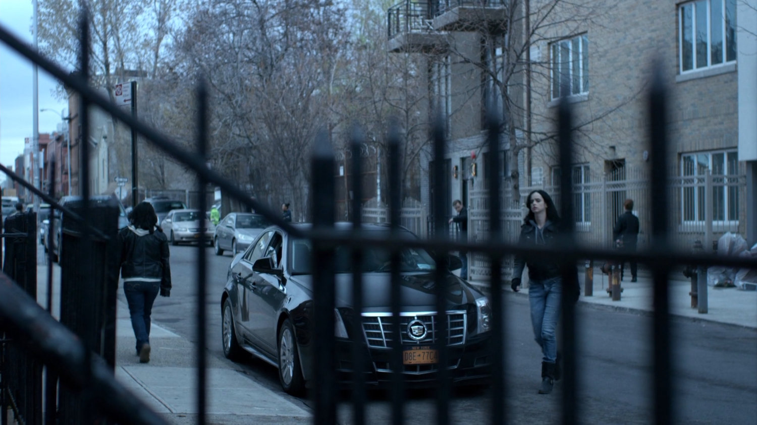 Jessica crossing a street towards Antoine Grier's apartment.