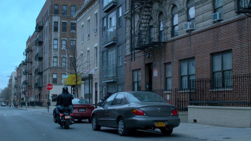 Luke and Jessica on motorcycle riding away from Antoine Grier's apartment building.