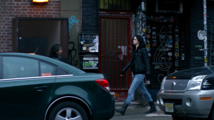 Jessica walking along sidewalk.