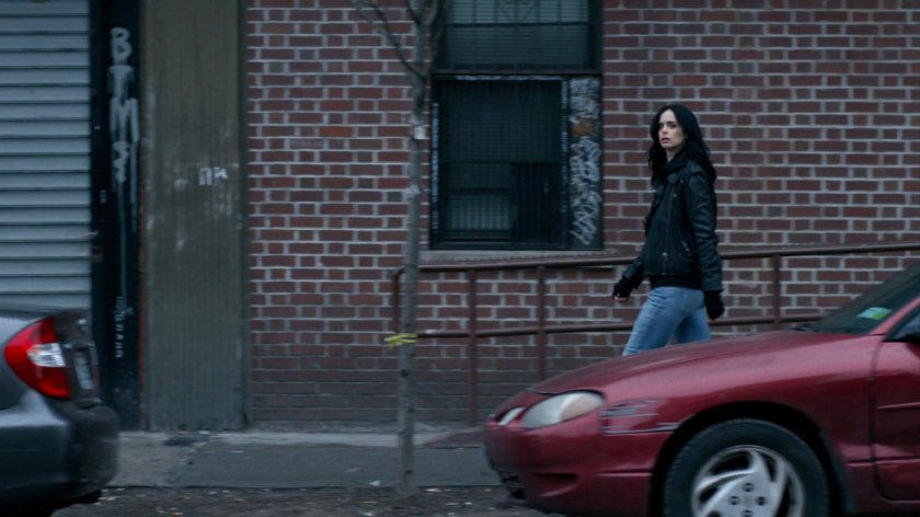 Jessica walking along sidewalk.