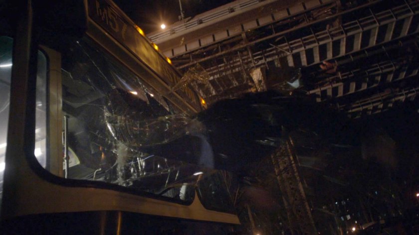 Bus driving being thrown through front window of bus.