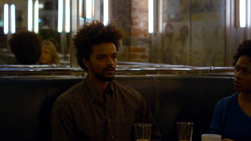 Malcolm talks to members of Kilgrave support group in a diner.