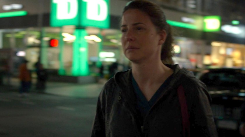 Wendy crossing a street at night.