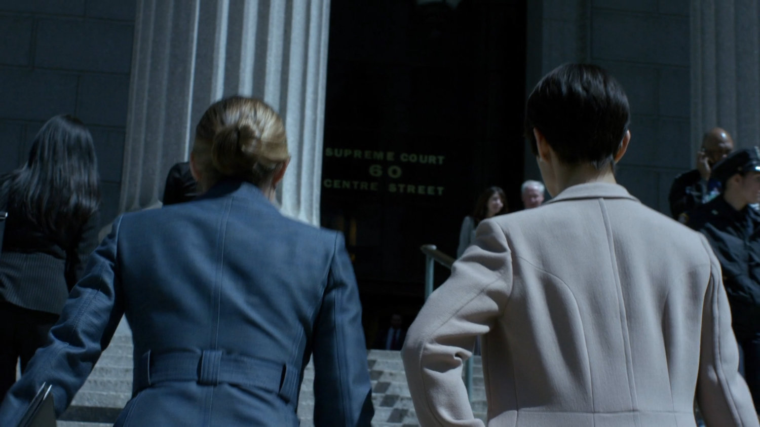 Jeri and Pam walking up steps to courthouse.