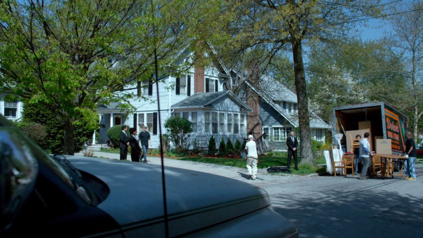 Movers and security guards outside Jessica's childhood home.