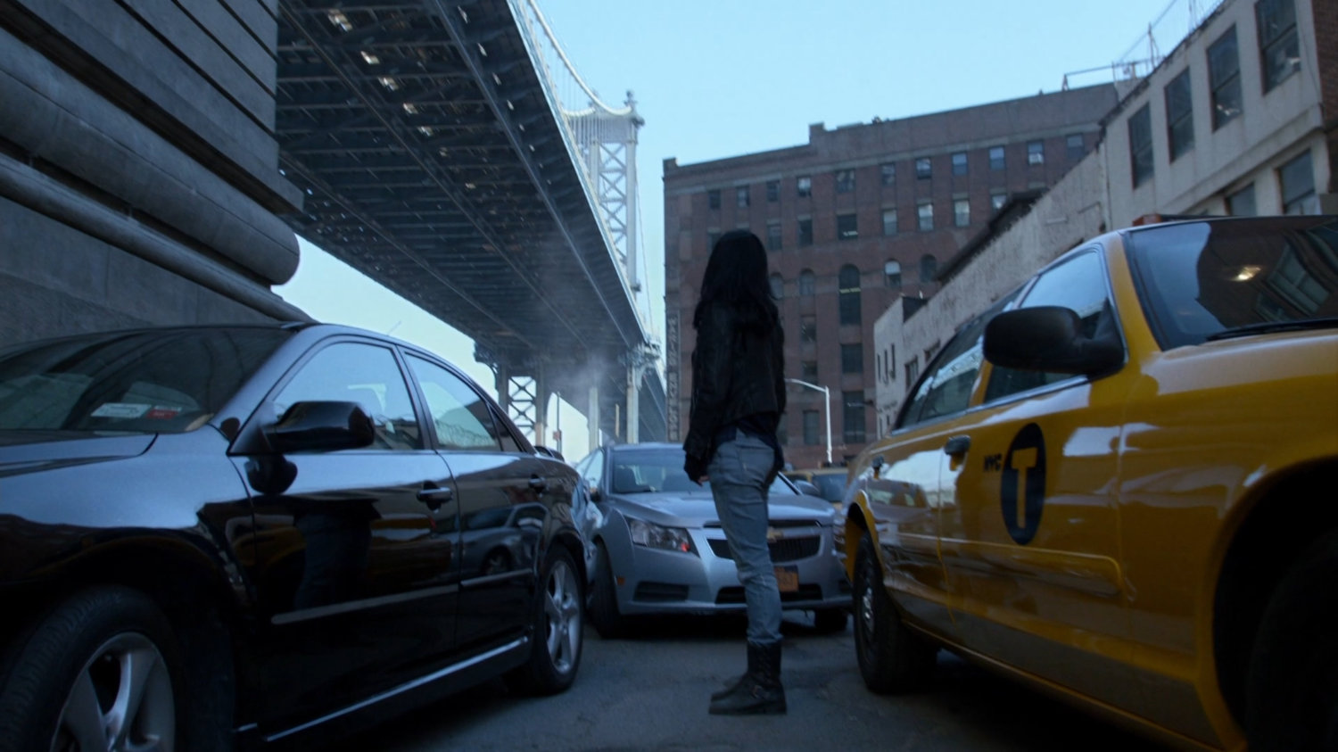 Jessica looking up at Manhattan Bridge during traffic jam.