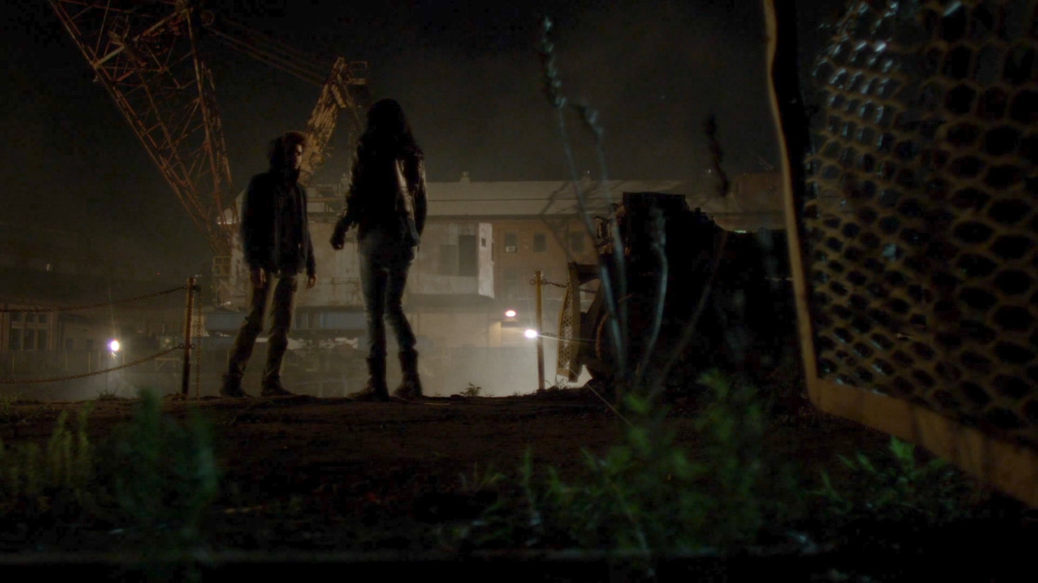 Jessica and Malcolm standing by dock at night.