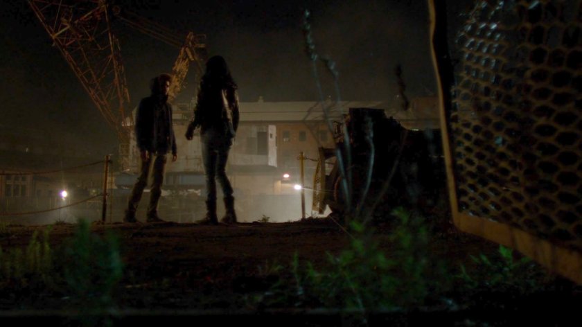 Jessica and Malcolm standing by dock at night.