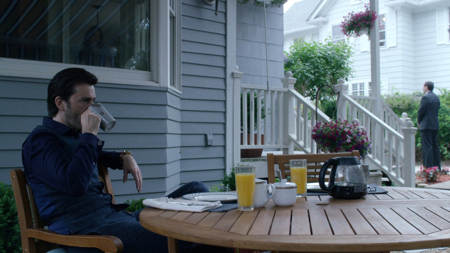 Kilgrave at a table on back porch of Jessica's childhood home.