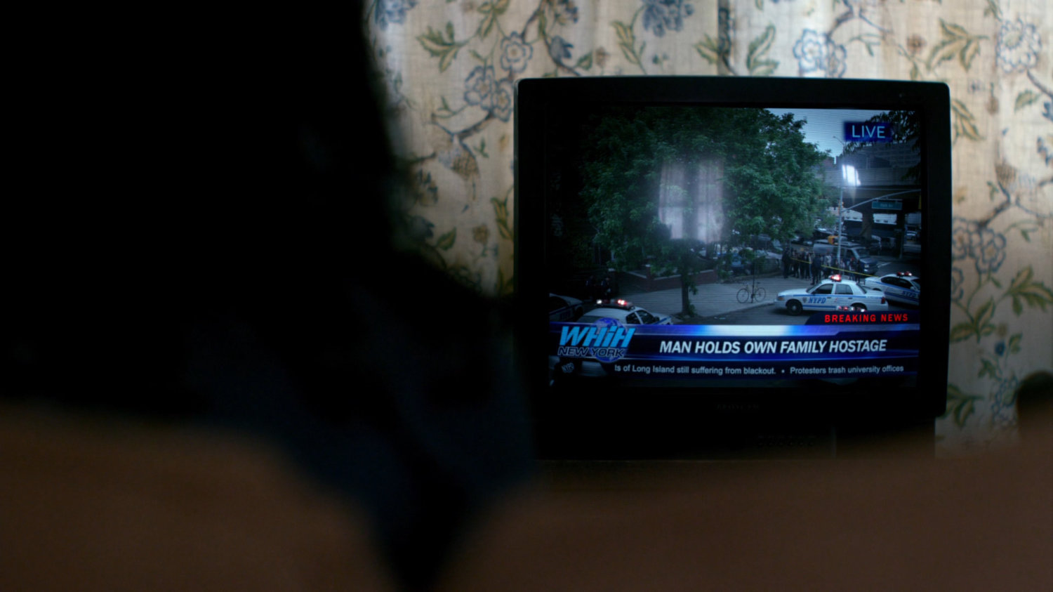 Television showing report on hostage situation.