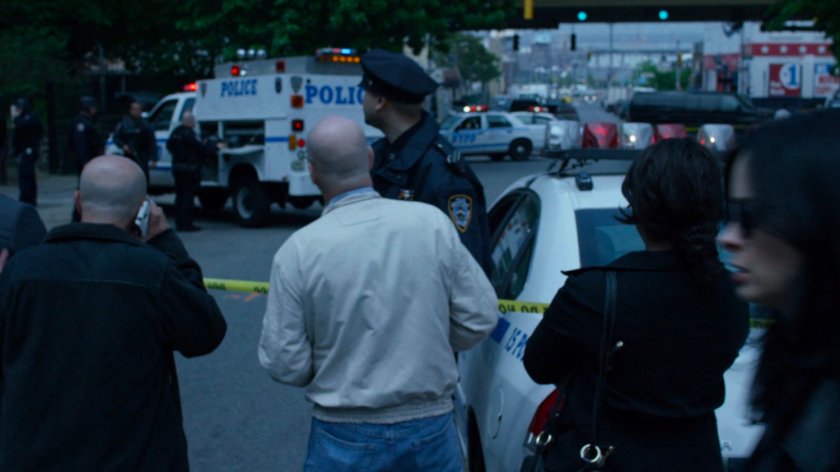 Onlookers and Police outside a hostage situation.