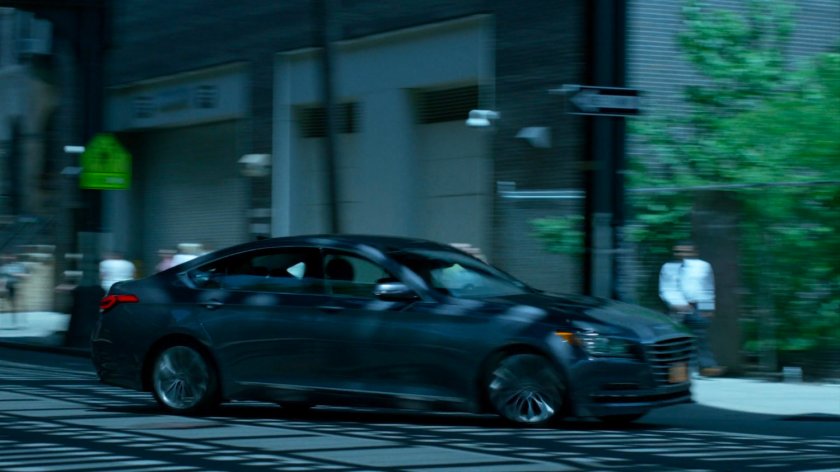 Trish's car speeding through city streets under overpass.