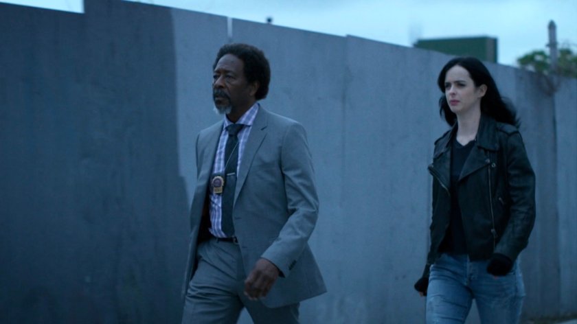 Jessica and Detective Clemons on a sidewalk.