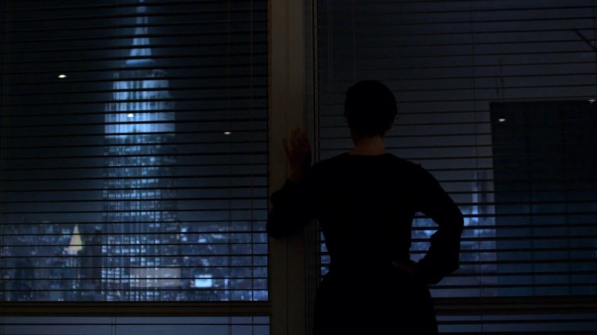 Jeri Hogarth looking out the window of her office at night.
