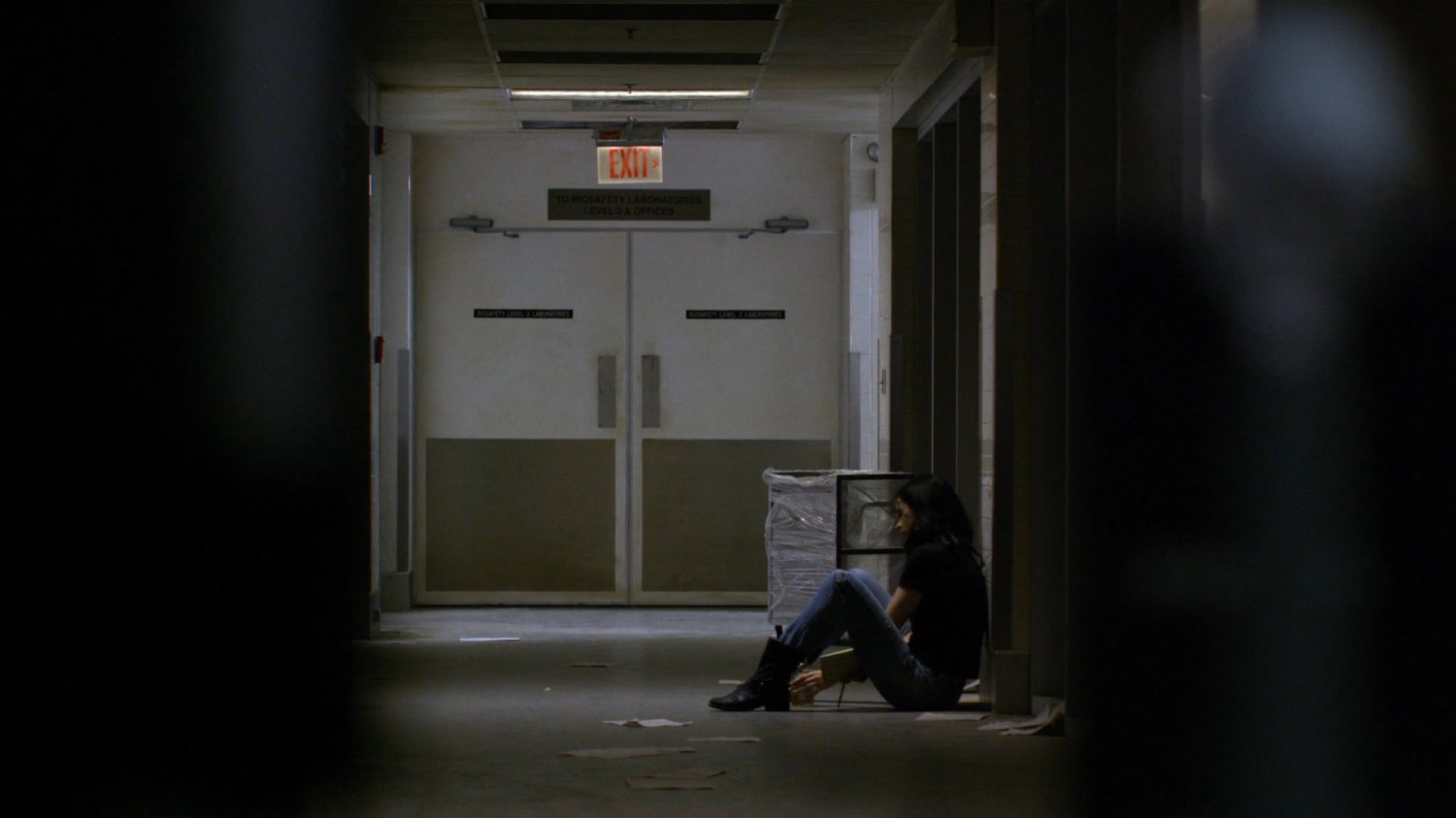 Jessica sitting in hallway of CDC facility.