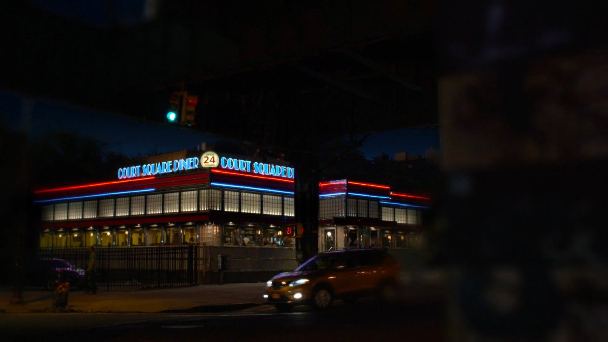 Exterior of Court Square Diner at night.