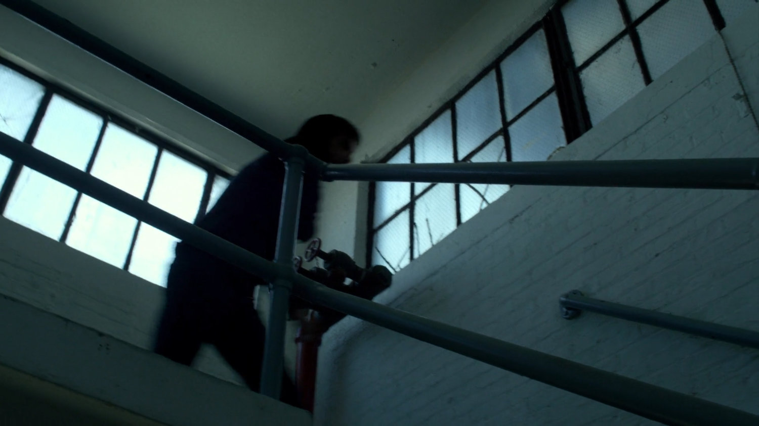 Kilgrave running down stairway inside CDC Facility.
