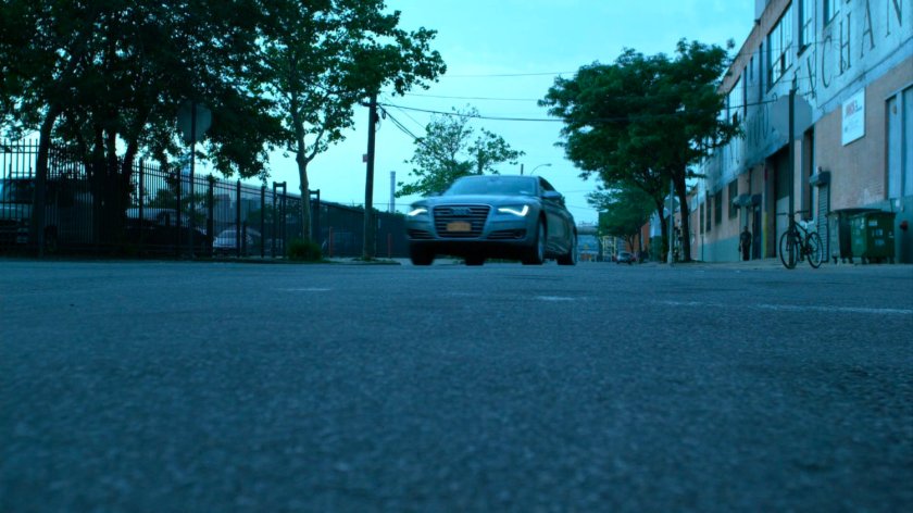 Hogarth's car driving on street.