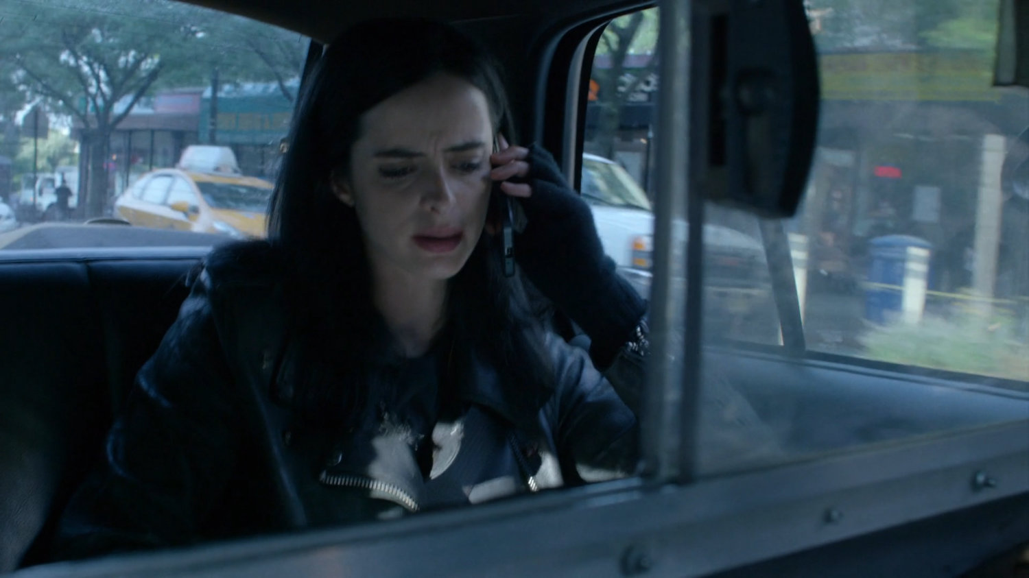 Jessica in the back of a taxi cab.
