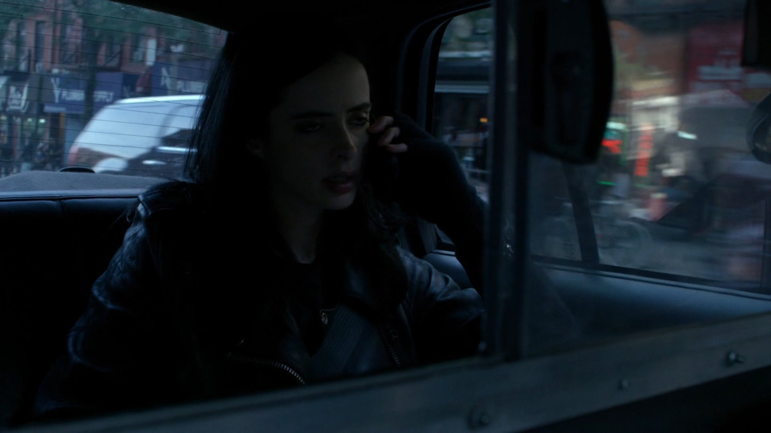 Jessica in the back of a taxi cab.