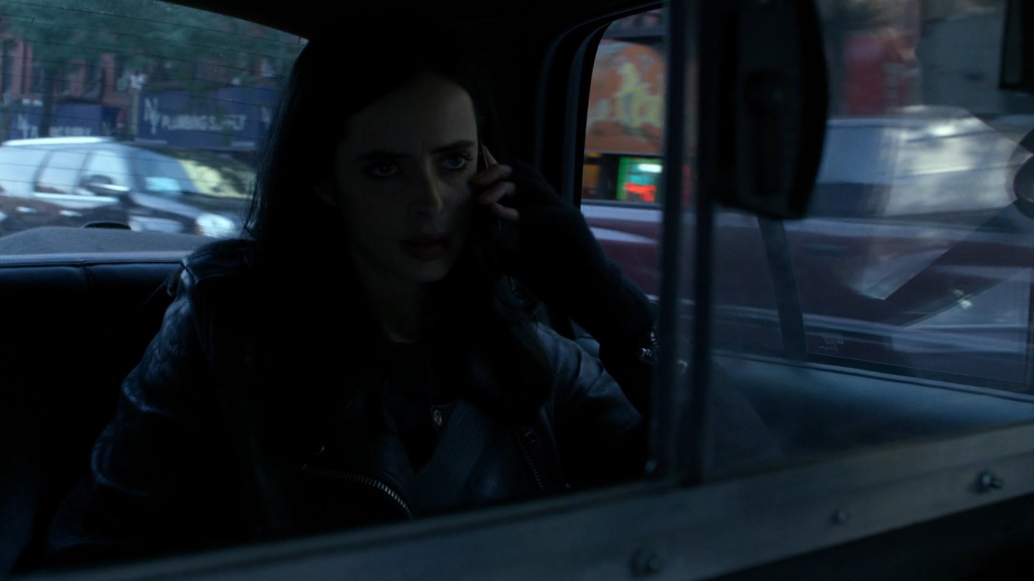 Jessica in the back of a taxi cab.