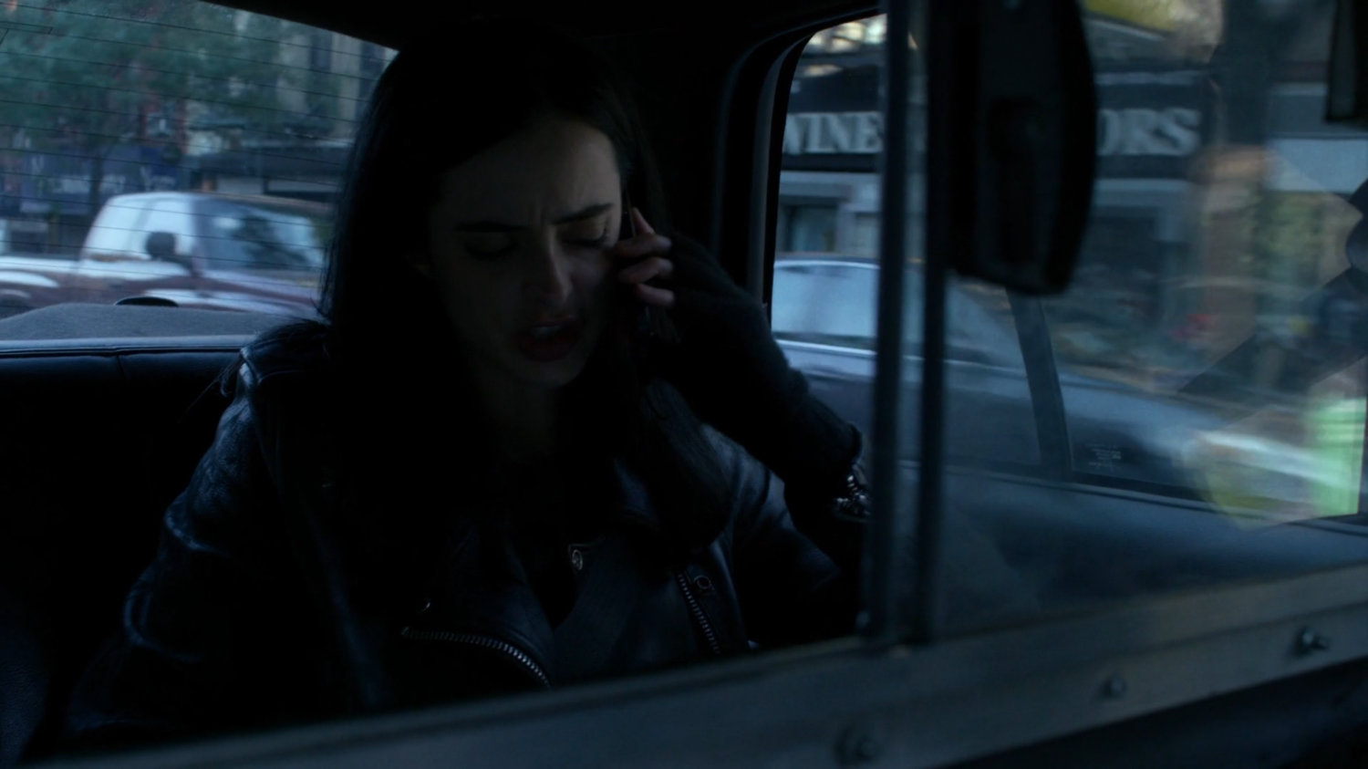 Jessica in the back of a taxi cab.