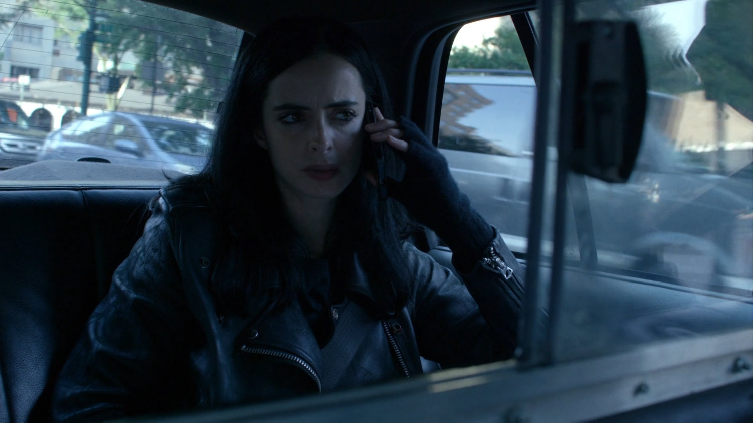 Jessica in the back of a taxi cab.