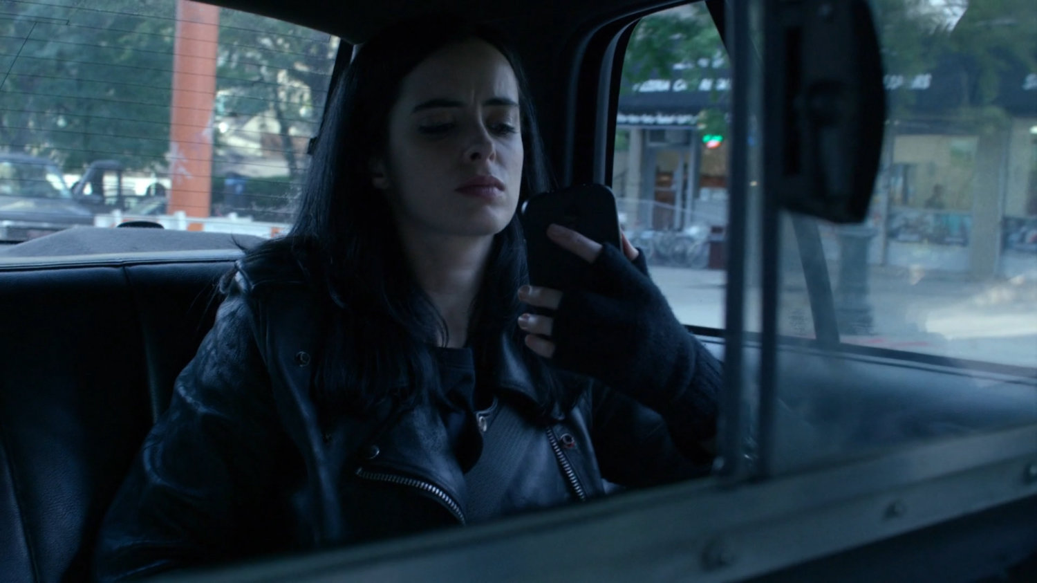 Jessica in the back of a taxi cab.