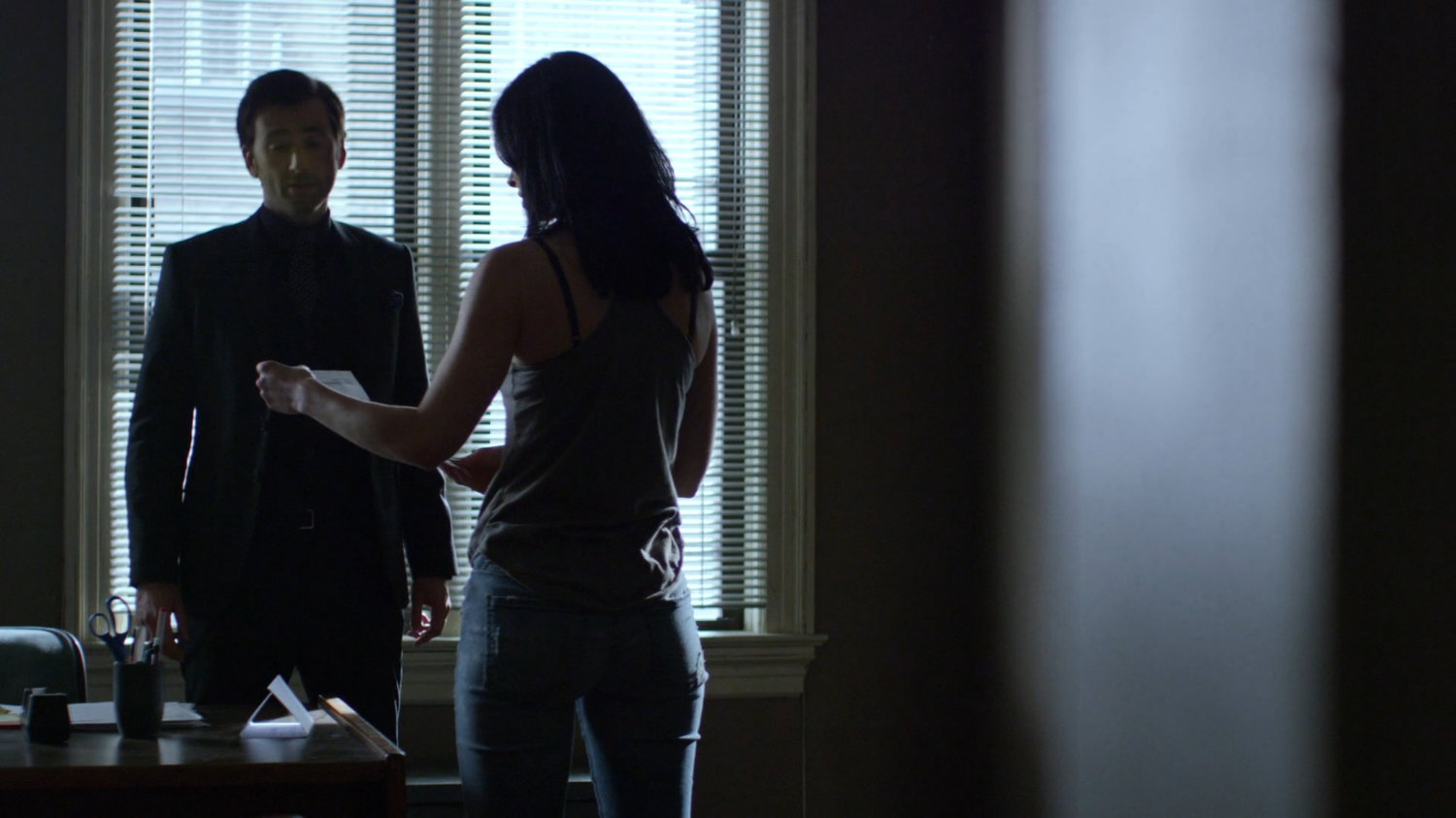 Jessica and Kilgrave in her office.
