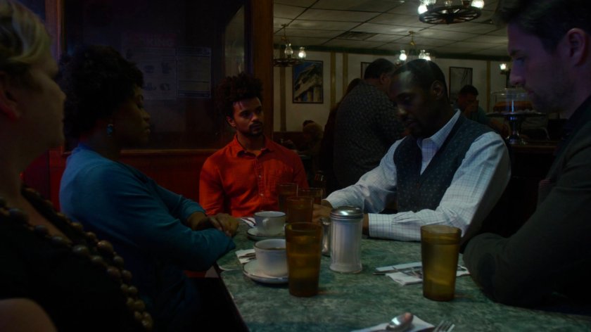 Malcolm and other Kilgrave's anonymous members meeting in Broadway Restaurant at night.