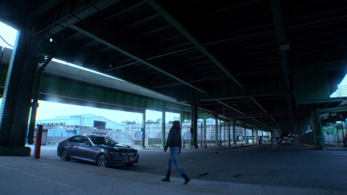 Jessica walking to Trish's car under overpass.