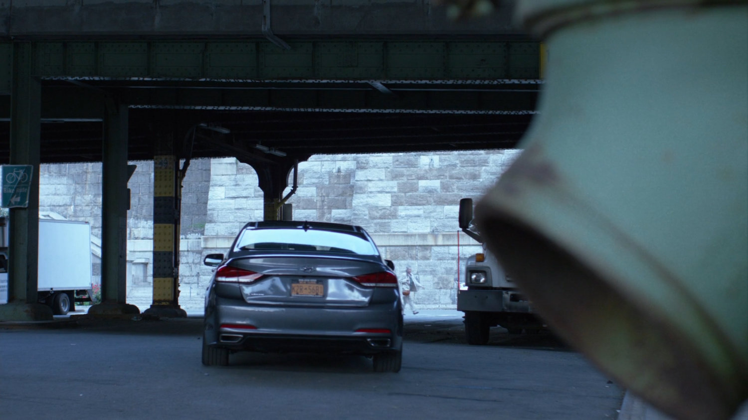Trish's car driving under overpass.