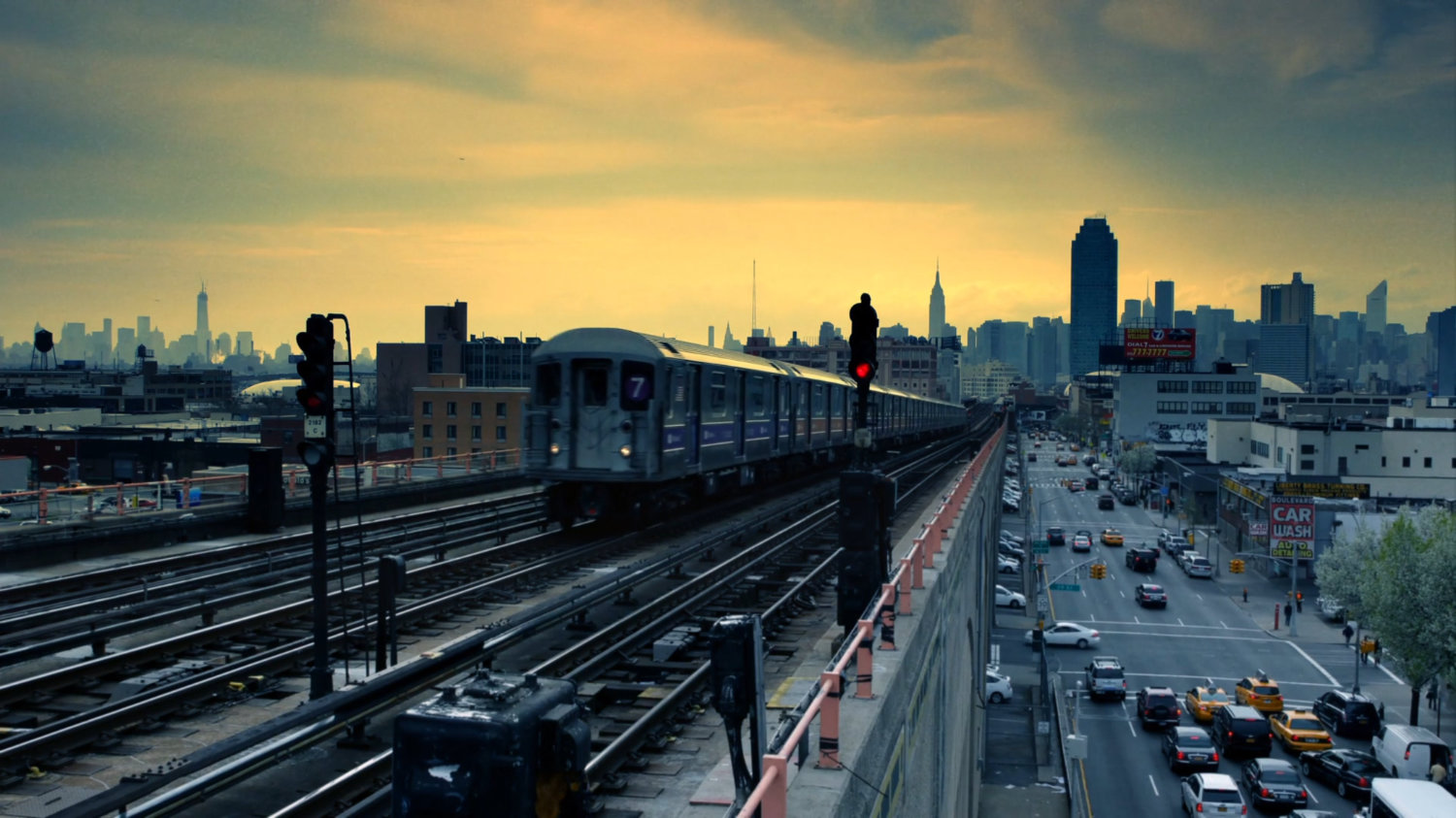 Elevated train drives along tracks at sunrise in New York.