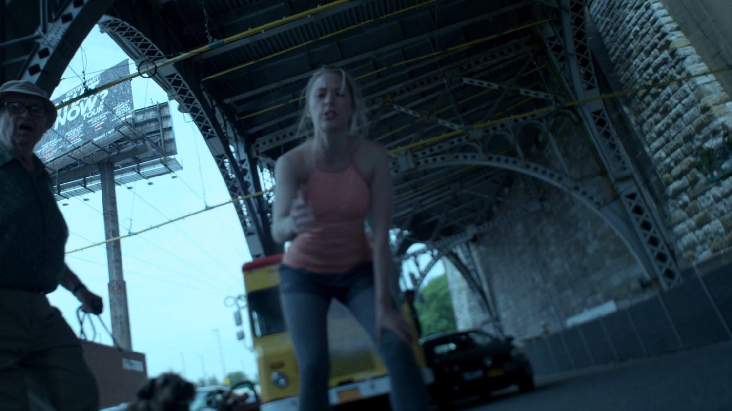 Woman trying to help Jessica up under overpass.