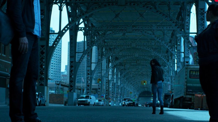 Jessica walking away under overpass.