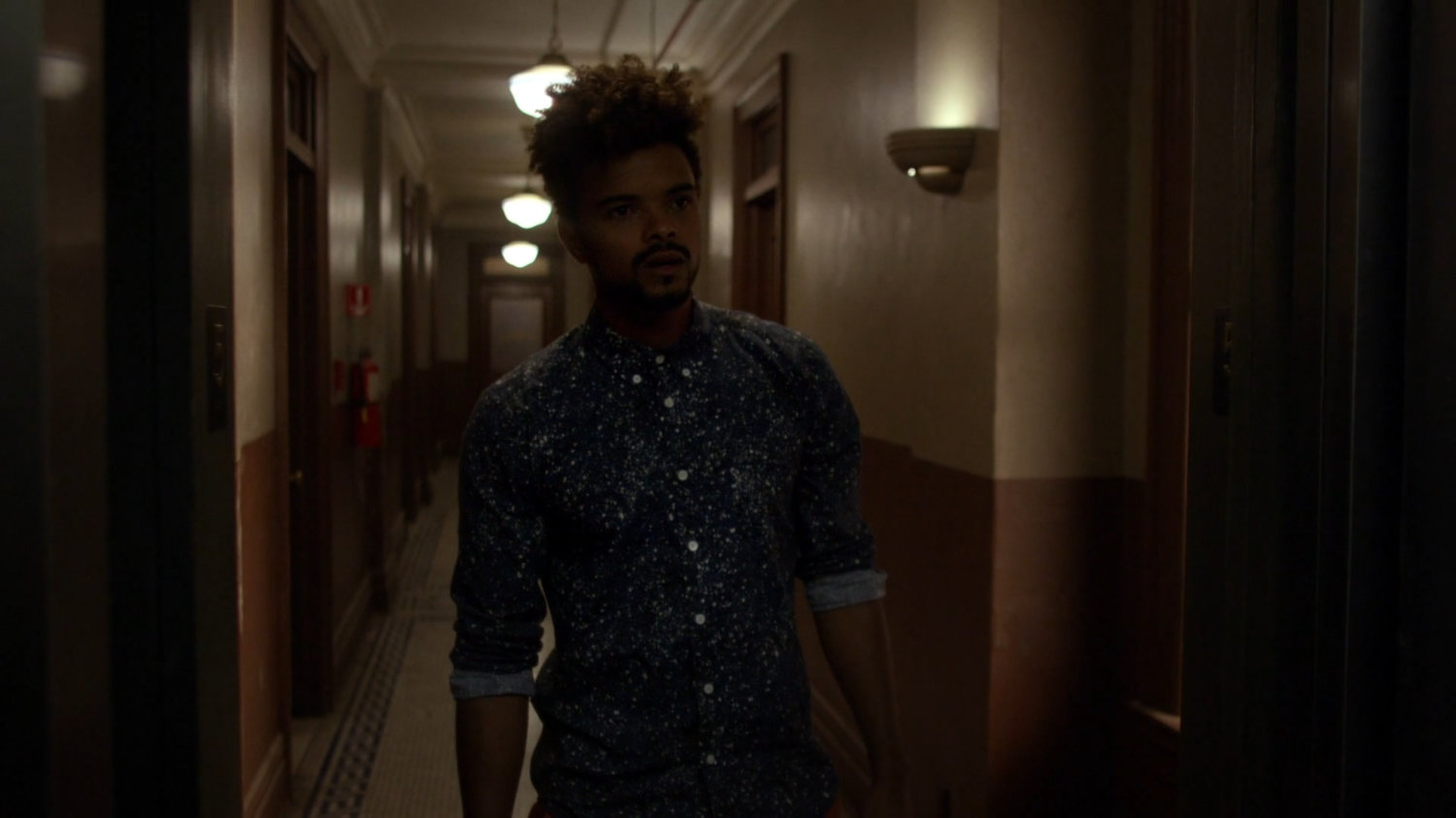 Malcolm in hallway outside Alias Investigations.