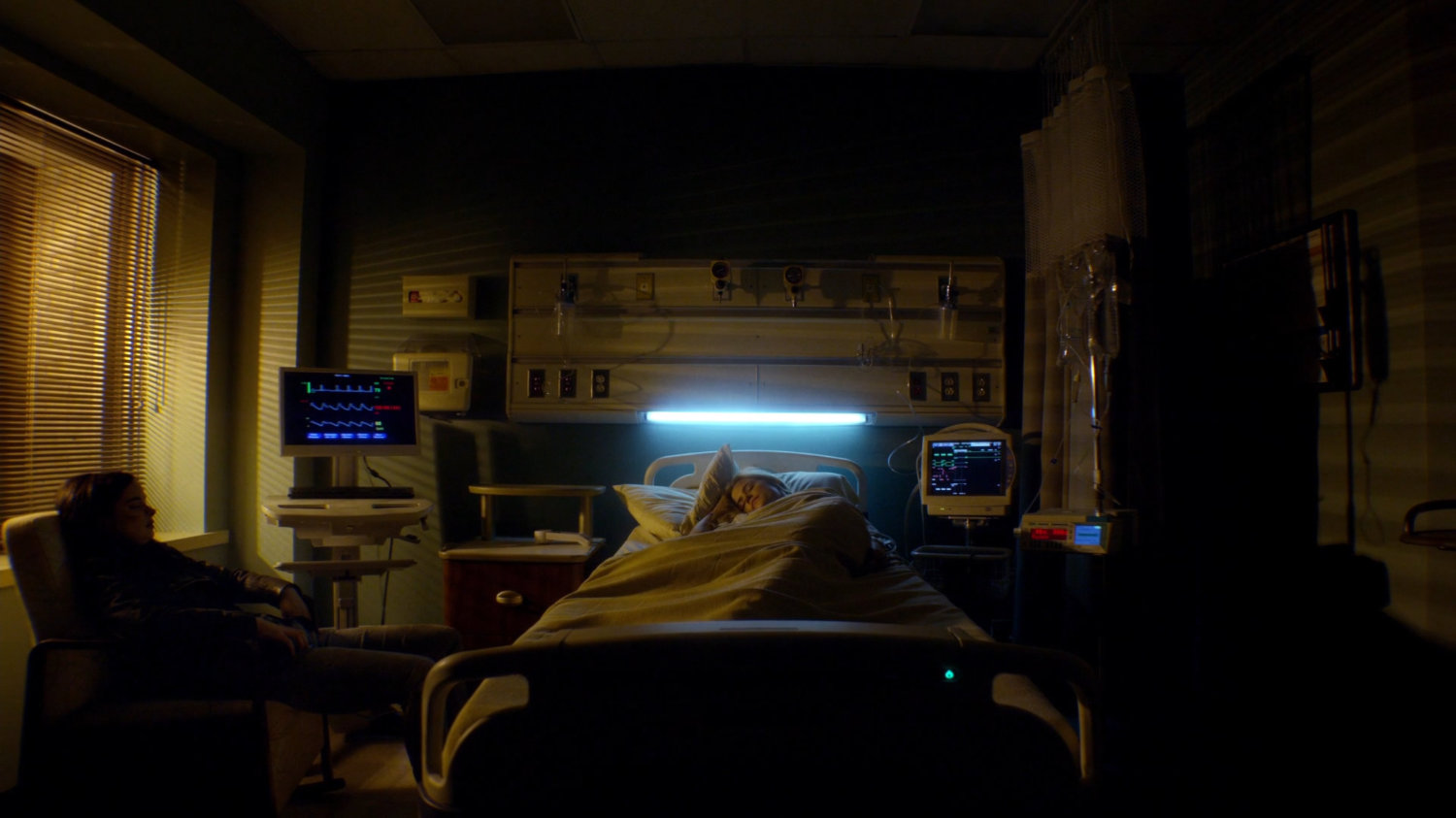 Jessica and Trish sleeping in hospital room.