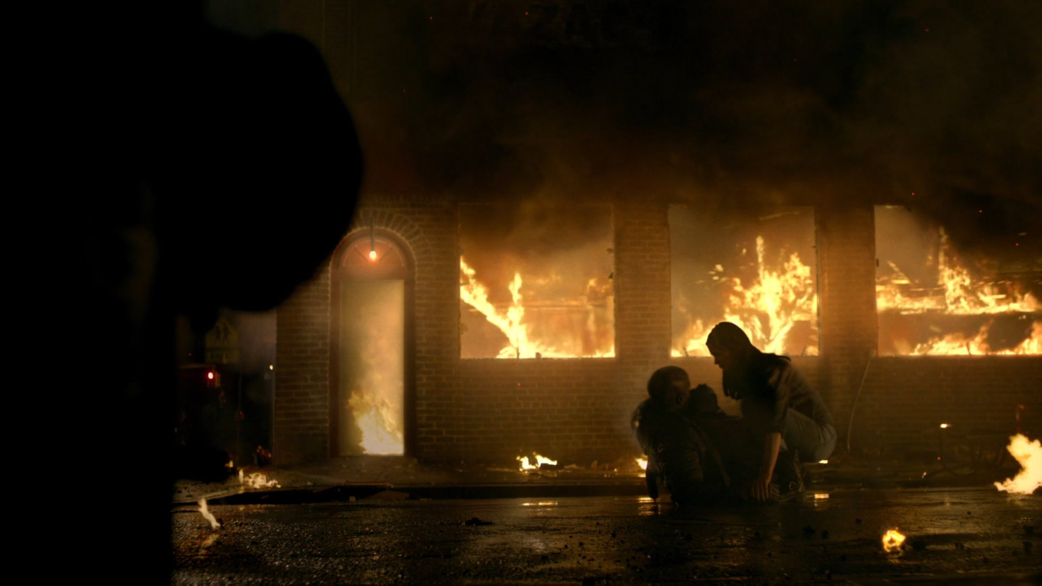 Jessica and Luke in street outside bar on fire.