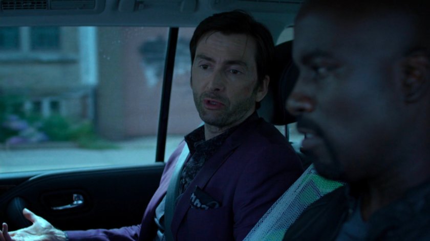 Luke and Kilgrave on back seat of car.