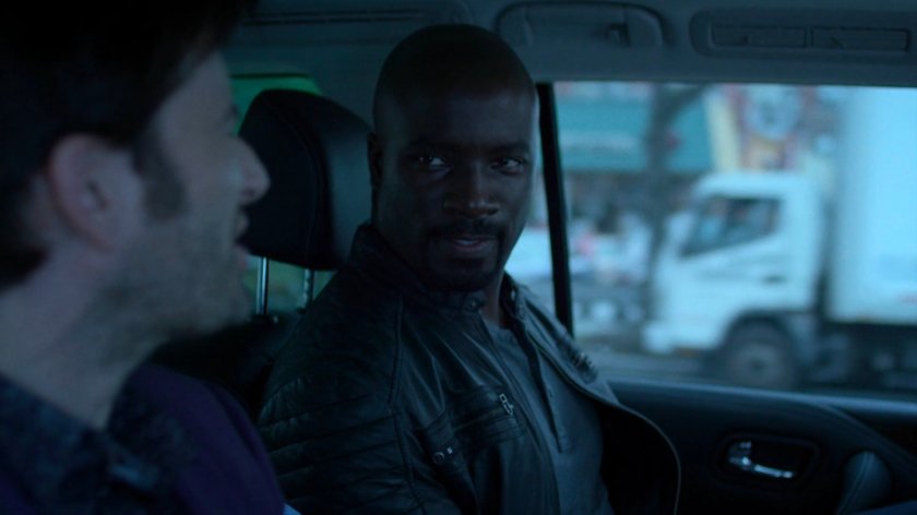 Luke and Kilgrave on back seat of car.