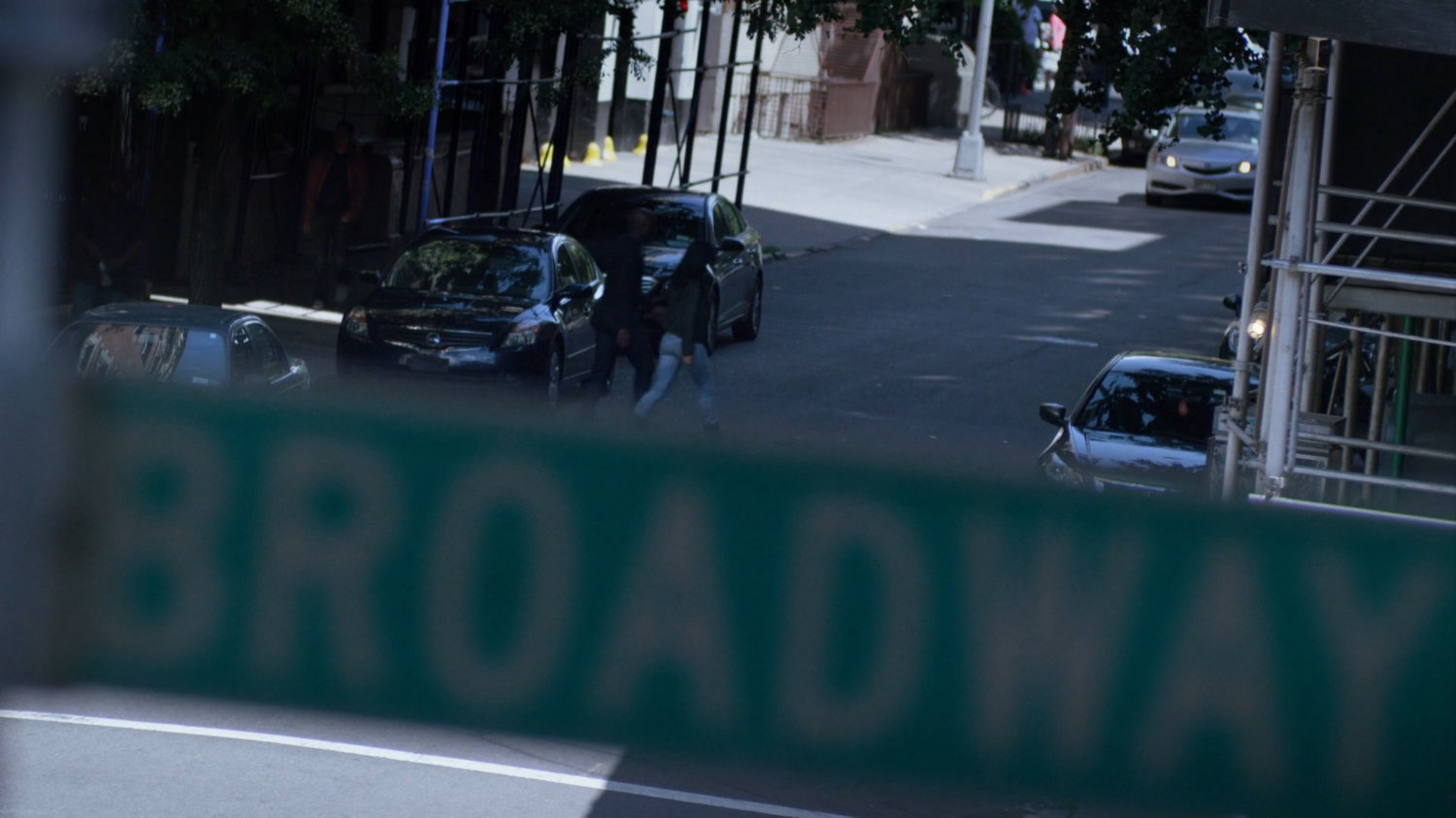 Luke and Jessica crossing street in front of Alias Investigations building.